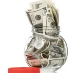 Many dollars in a glass jar isolated on white background